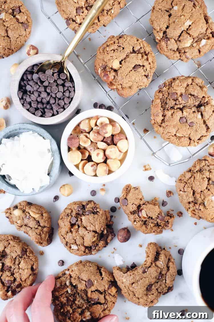 Close-up of Hazelnut Chocolate Chip Cookies, highlighting the textures of nuts, coconut, and chocolate chips. | realsimplegood.com