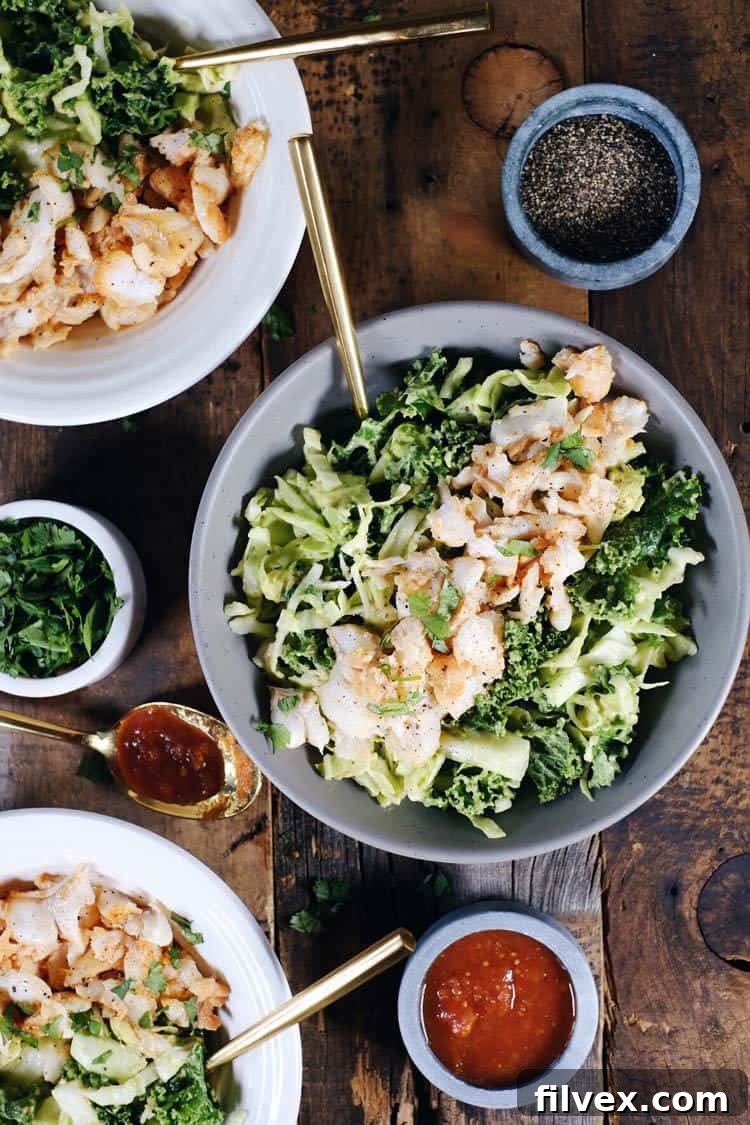 These Paleo fish taco bowls are a fresh spin on tacos and can be made in 25 minutes! Whole30 and easy to make, serve these in a bowl over a creamy slaw. Paleo, Whole30, Gluten-Free + Dairy-Free. | realsimplegood.com