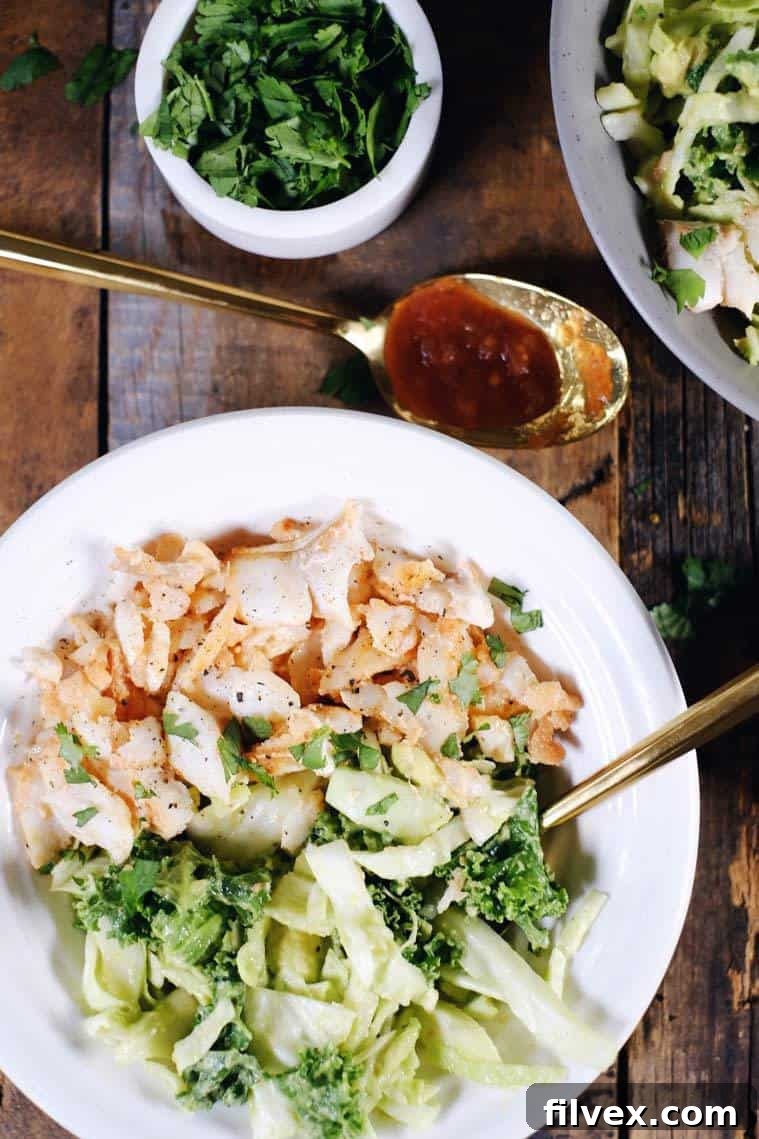 These Paleo fish taco bowls are a fresh spin on tacos and can be made in 25 minutes! Whole30 and easy to make, serve these in a bowl over a creamy slaw. Paleo, Whole30, Gluten-Free + Dairy-Free. | realsimplegood.com