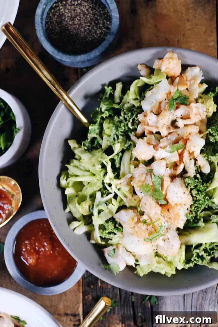 These Paleo fish taco bowls are a fresh spin on tacos and can be made in 25 minutes! Whole30 and easy to make, serve these in a bowl over a creamy slaw. Paleo, Whole30, Gluten-Free + Dairy-Free. | realsimplegood.com