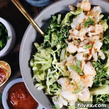 Paleo Fish Taco Bowls with creamy avocado slaw and fresh toppings.