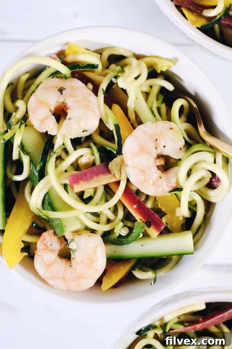 This Shrimp Zoodle Spring Roll Bowl comes together quickly, combining fresh vegetables, perfectly cooked shrimp, and a zesty dressing for a colorful and flavor-packed meal. Paleo, Whole30, Gluten-Free, Soy-Free, Dairy-Free.