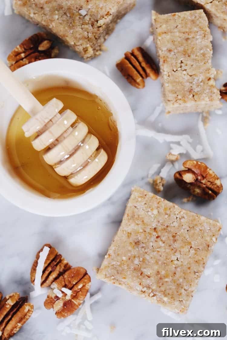 Close-up of clean ingredients for honey nut bars: various nuts, shredded coconut, and honey, emphasizing healthy eating.