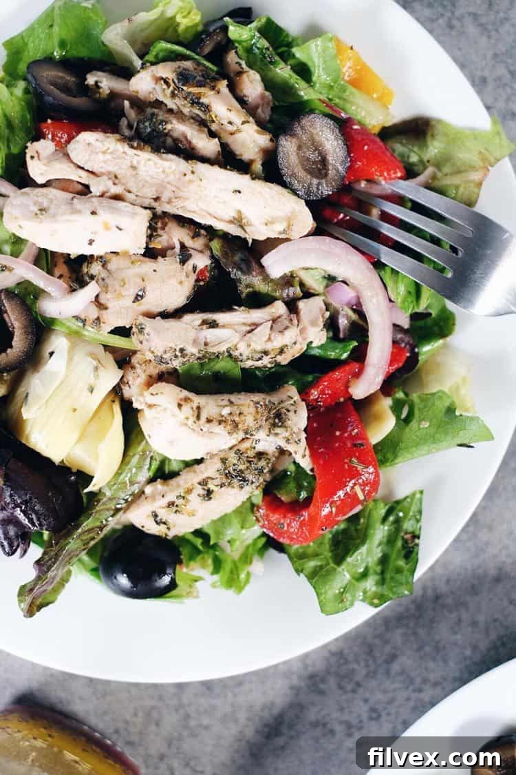 Fresh, vibrant, and incredibly flavorful Mediterranean Chicken Salad, perfect for a healthy and quick meal. It's packed with crisp lettuce, tender chicken, olives, roasted peppers, artichoke hearts, red onion, and a homemade dressing, making it Paleo and Whole30 friendly.