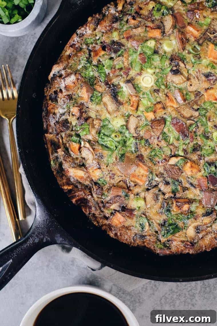 Delicious slice of Bacon Sweet Potato Frittata on a plate, ready for a healthy breakfast. Paleo and Whole30 compliant.