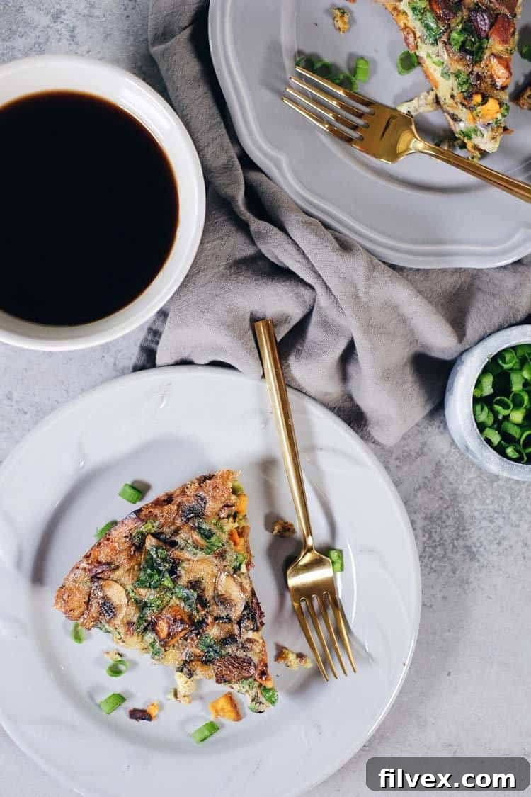 Close-up of a rustic Bacon Sweet Potato Frittata baking in an oven-safe skillet. Paleo and Whole30 friendly.