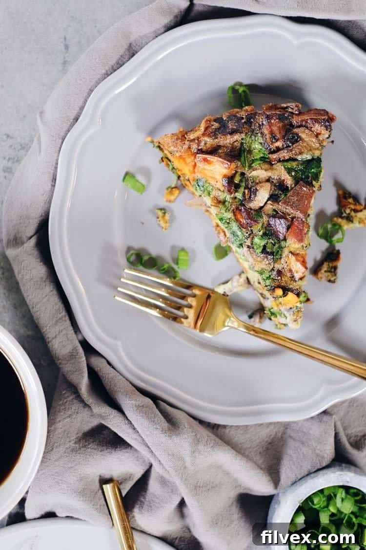 A whole Bacon Sweet Potato Frittata cooling on a wire rack, showcasing its golden-brown top. A healthy, make-ahead breakfast.