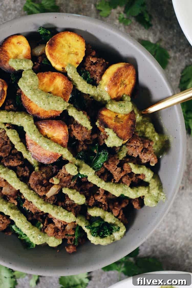 Flavorful Ground Beef and Plantain Bowls with a vibrant green sauce, perfect for Paleo and Whole30 diets.