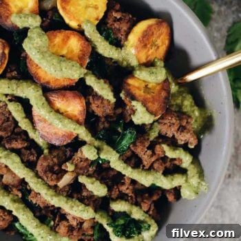 Ground beef and plantain bowls with green sauce on top