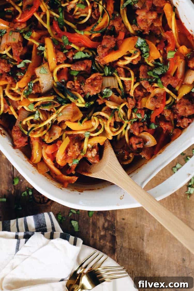This Paleo and Whole30 easy zucchini casserole is packed with veggies and a breeze to make! It's filled with Italian sausage, bell peppers and onions! Paleo + Whole30 | realsimplegood.com