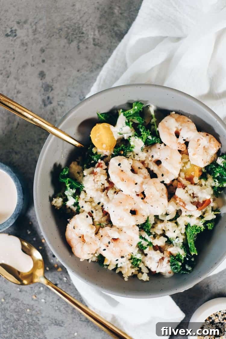 Preparing the quick and easy Paleo cauliflower rice and shrimp recipe in a skillet.
