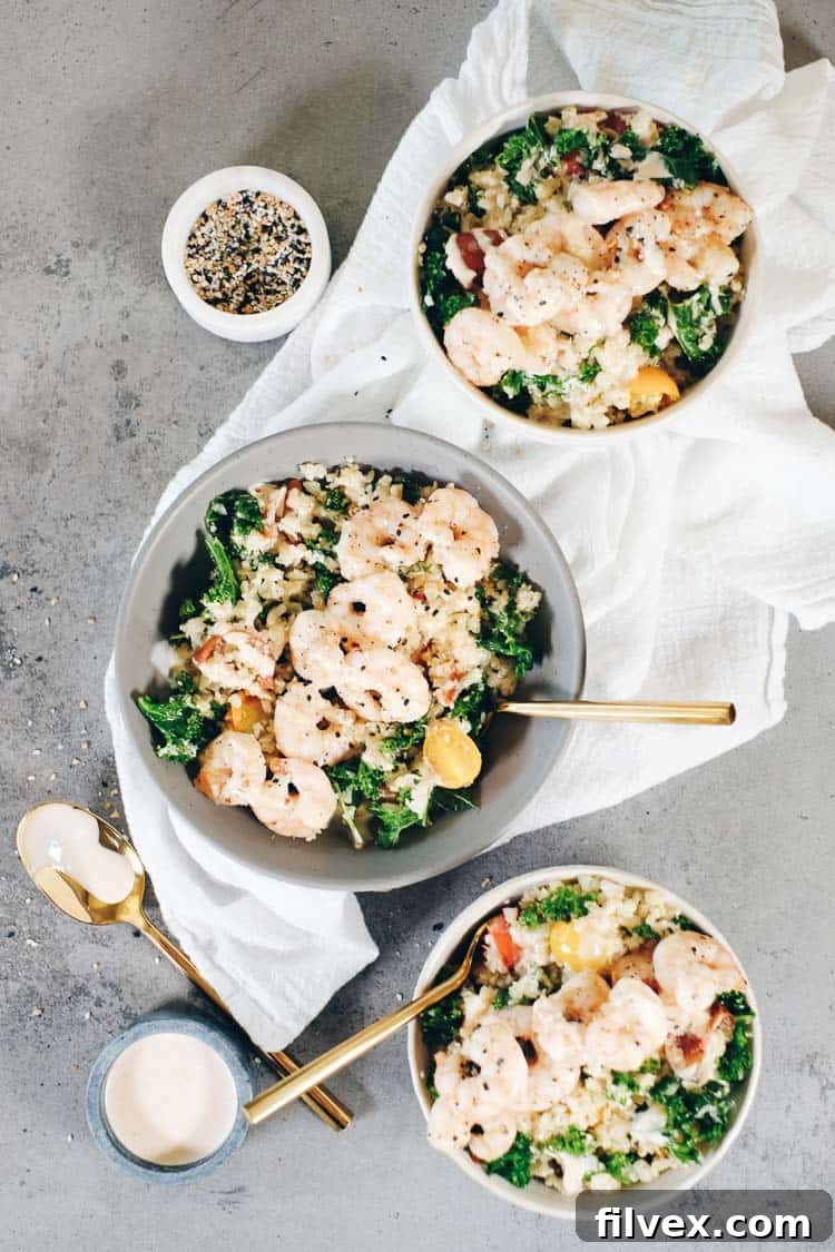 A close-up of a completed Paleo shrimp and cauliflower rice bowl, ready to be enjoyed.