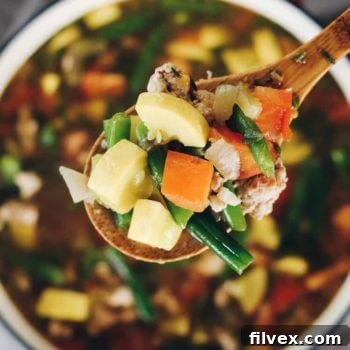 A hearty bowl of Paleo and Whole30 Turkey and Summer Vegetable Soup, showcasing its rich texture and wholesome ingredients, perfect for a healthy meal.