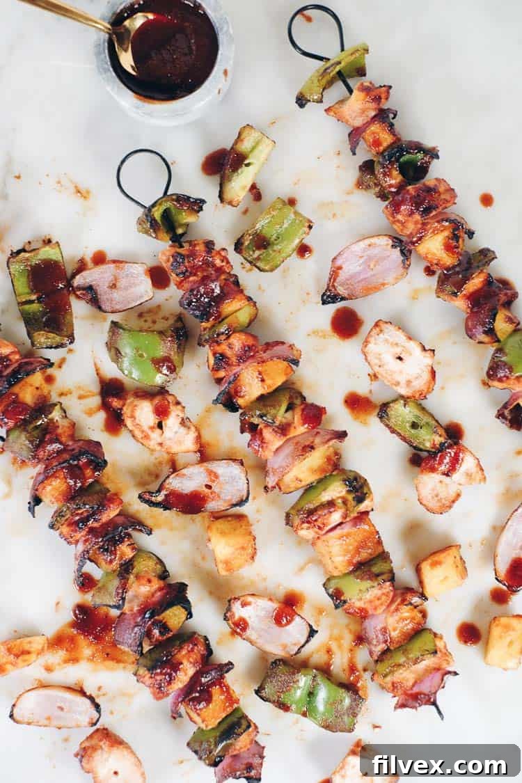 Grilled Hawaiian chicken kabobs with pineapple, bell peppers, and red onion, served on a platter. These healthy kabobs are perfect for summer barbecues.