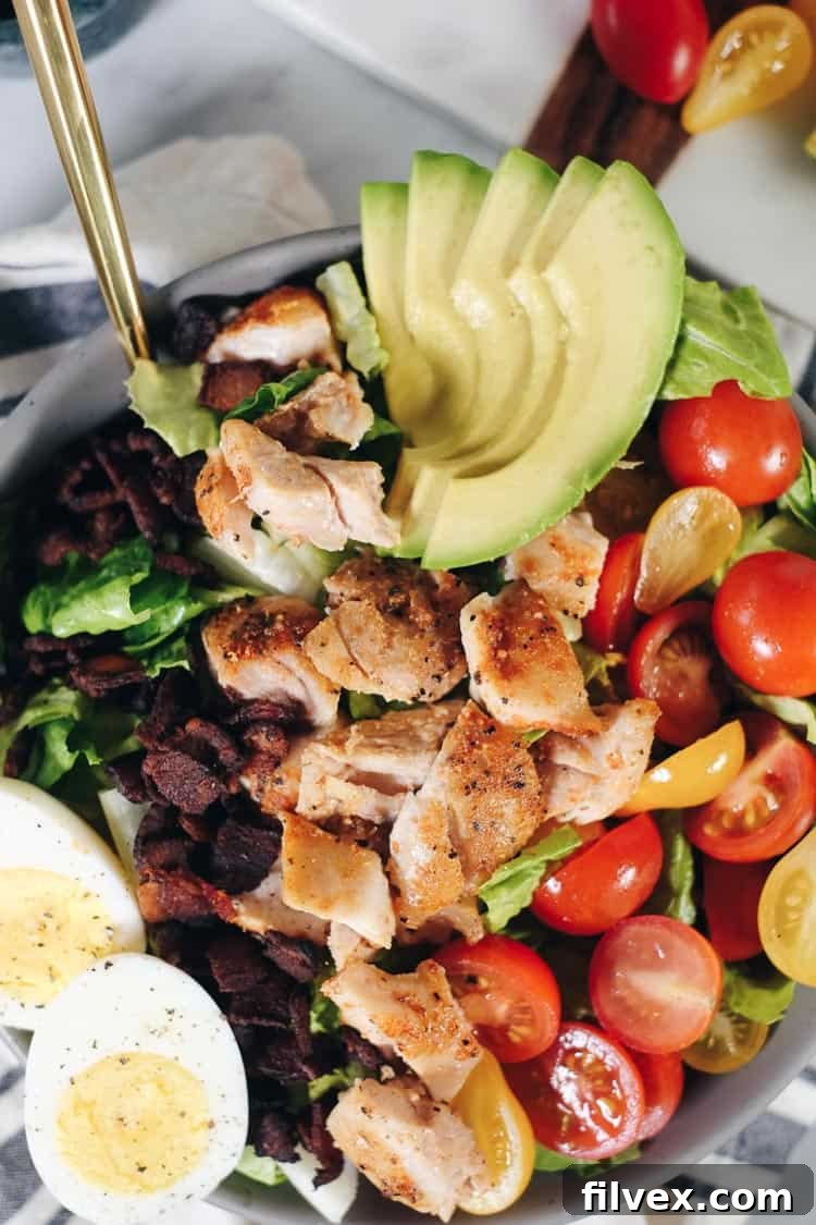 Close-up of the seasoned chicken for the Easy Paleo Cobb Salad, showing the simple yet effective seasoning blend of garlic powder, paprika, salt, and pepper.