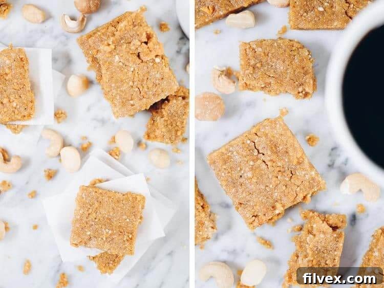 Vibrant yellow no-bake mango bars arranged on a white cutting board, showcasing their chewy texture and the subtle speckles of coconut and nuts. Perfect for a quick, healthy snack and meal prep.