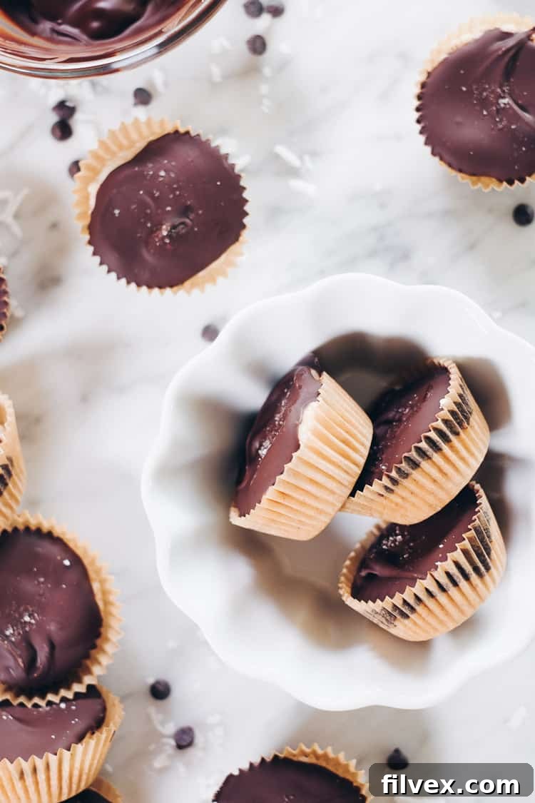 Simple steps to make Paleo Coconut Butter Cups, a wholesome and quick no-bake recipe for health-conscious snackers.