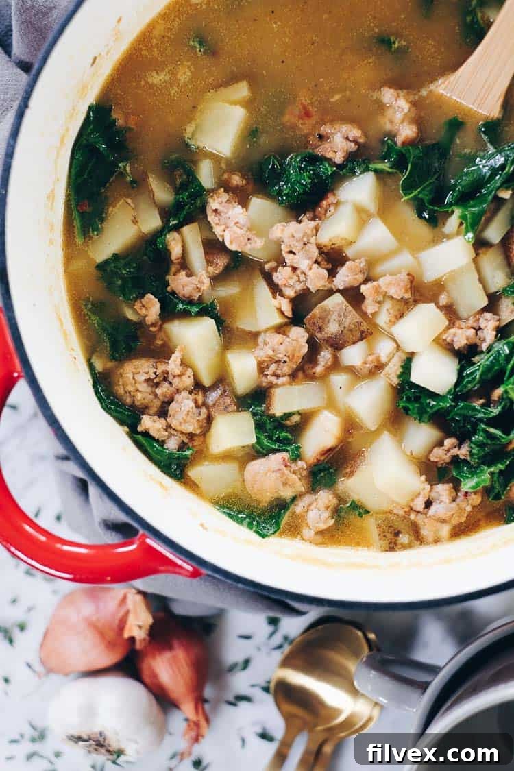 Close-up of golden brown roasted garlic heads, ready to be added to the soup.