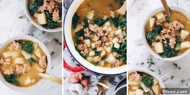 A large pot of Paleo sausage soup simmering on the stovetop, filled with sausage, potatoes, and kale.