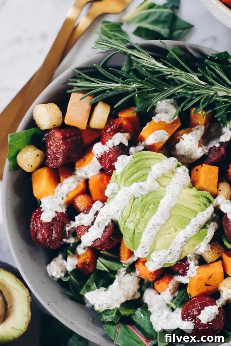 Close-up of creamy homemade ranch dressing being drizzled over a bowl of Sheet Pan Roasted Sausage and Vegetables, highlighting its rich texture and appetizing appeal.
