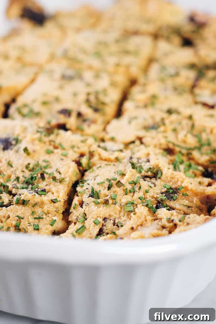 Close-up, angled view of Loaded Cauliflower Casserole, emphasizing the rich texture and ingredients