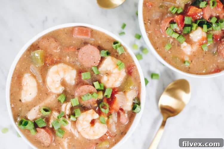 This Slow Cooker Paleo Gumbo is packed with tender chicken thighs, savory sausage, and plump shrimp, alongside an abundance of fresh vegetables and aromatic seasonings. It's also fully compliant with Whole30 and Keto dietary plans, making it a healthy and flavorful choice for any meal. | realsimplegood.com