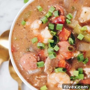 A hearty bowl of Slow Cooker Paleo Gumbo with chicken, sausage, shrimp, and vegetables.