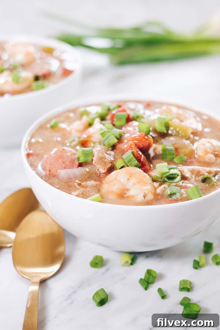 This hearty Paleo Gumbo is generously loaded with succulent chicken thighs, robust sausage, and fresh shrimp, complemented by a colorful medley of vegetables and a rich blend of seasonings. It's a fantastic Whole30 and Keto-friendly option that doesn't compromise on taste. | realsimplegood.com