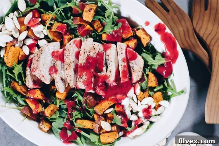 Elevate your holiday table with this vibrant Roasted Sweet Potato Salad, featuring a festive cranberry vinaigrette, perfect for fall celebrations.