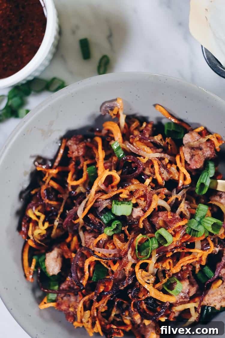 Enjoy the delicious flavors and textures of this Paleo and Whole30 Sheet Pan Crispy Vegetable Noodles and Pork recipe! You will crave the leftovers! | realsimplegood.com