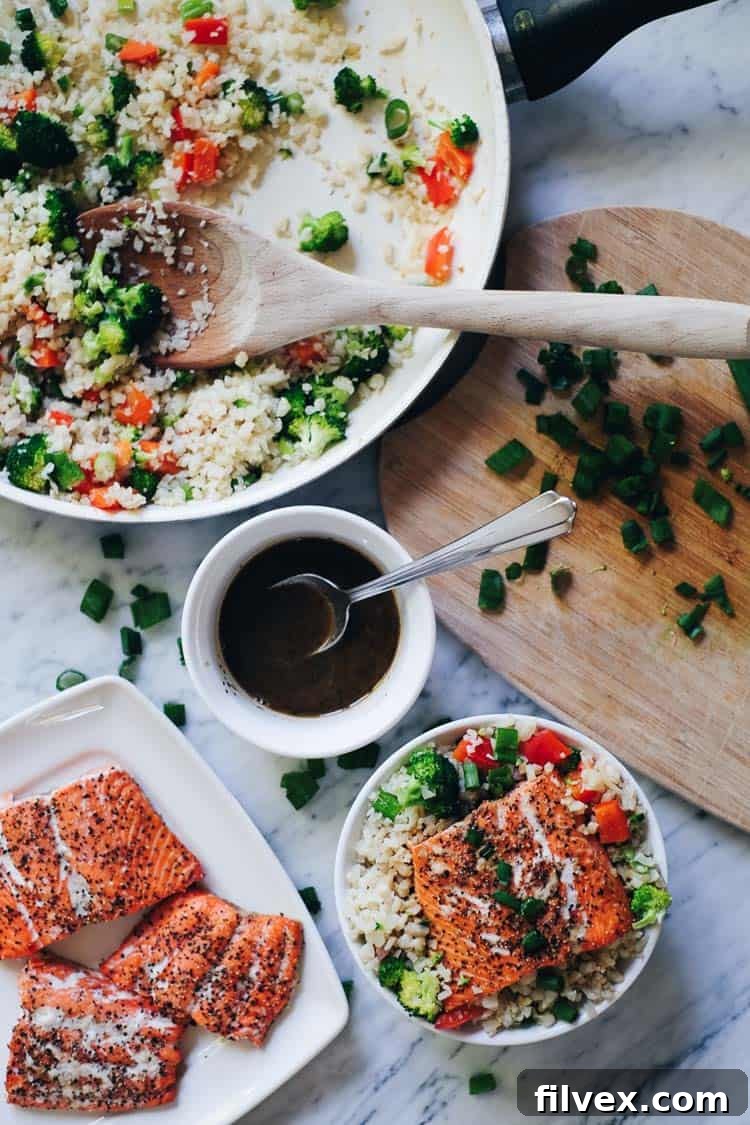 Close-up of a flavorful Honey Ginger Salmon Bowl, showcasing the beautifully baked salmon, vibrant vegetables, and rich homemade sauce. Ideal for healthy eating and meal prep, suitable for Paleo, Gluten-Free and Soy-Free diets. | realsimplegood.com