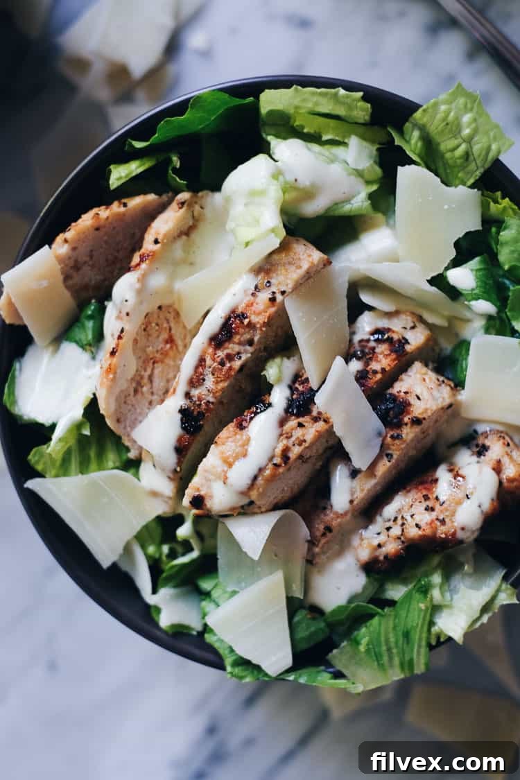 Healthy Caesar Turkey Burger Bowl without cheese, emphasizing Whole30 and Paleo compliance. Features fresh greens, turkey patty, and creamy dressing.