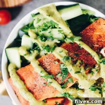 Close-up of a Paleo Salmon Salad Bowl with creamy avocado dressing