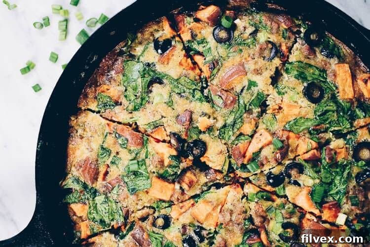 This Paleo + Whole30 sausage and sweet potato frittata is filling and full of the delicious flavors of sausage, sweet potatoes, olives and green onions. It will keep you going all morning! #paleo #whole30 #glutenfree #dairyfree #breakfast | realsimplegood.com