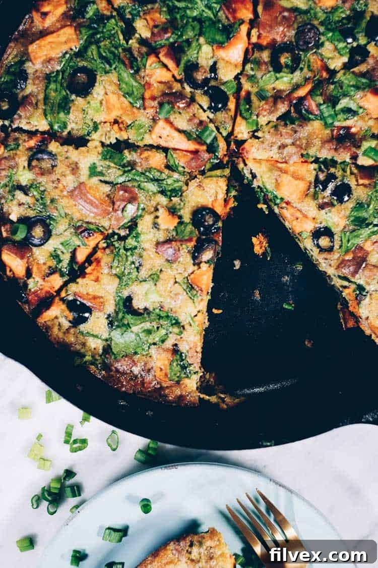 This Paleo + Whole30 sausage and sweet potato frittata is filling and full of the delicious flavors of sausage, sweet potatoes, olives and green onions. It will keep you going all morning! #paleo #whole30 #glutenfree #dairyfree #breakfast | realsimplegood.com