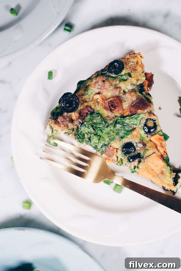 This Paleo + Whole30 sausage and sweet potato frittata is filling and full of the delicious flavors of sausage, sweet potatoes, olives and green onions. It will keep you going all morning! #paleo #whole30 #glutenfree #dairyfree #breakfast | realsimplegood.com