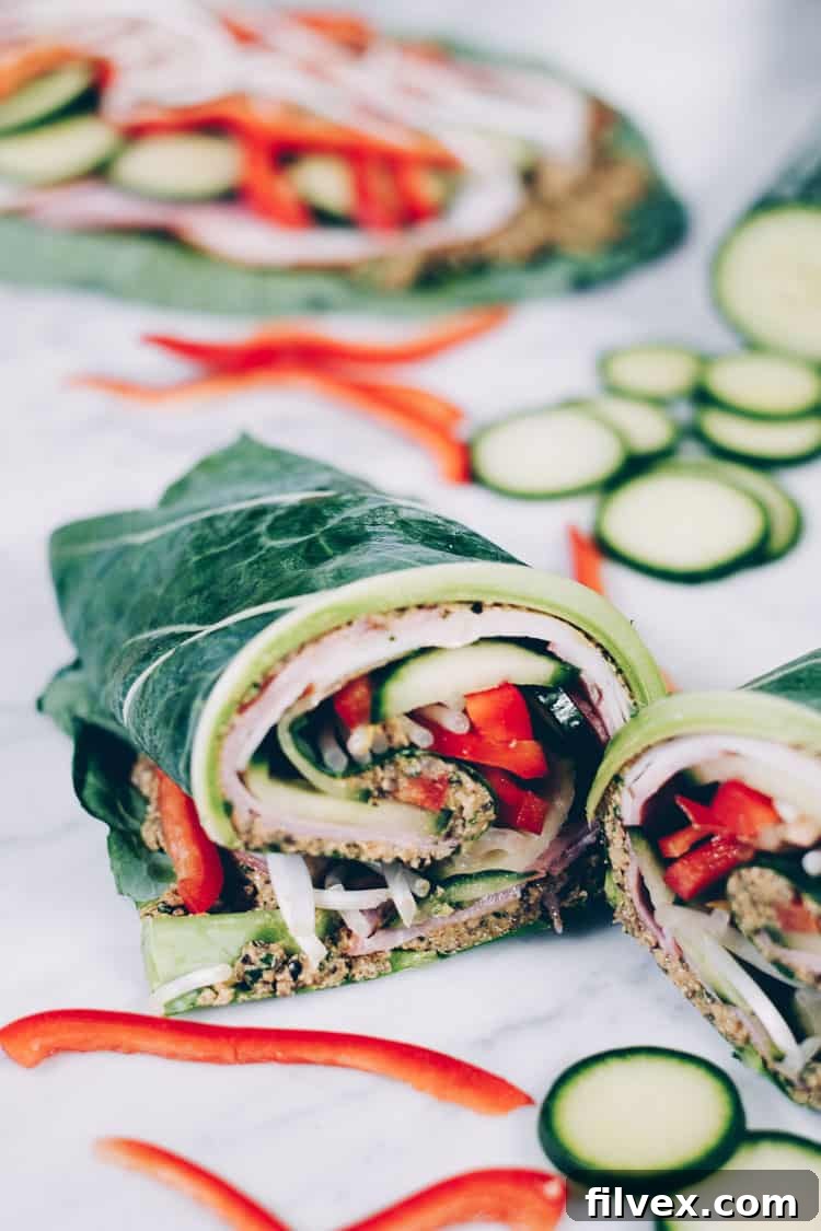 Close-up of a perfectly assembled collard green wrap, highlighting the turkey and crisp vegetables inside. A visually appealing and healthy option for Paleo and Whole30 diets.