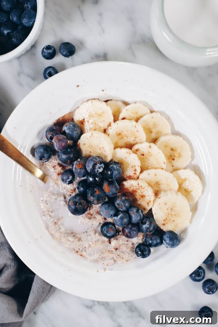 Close-up of a rustic spoon resting in a bowl of Paleo Overnight Oats, showcasing its thick, creamy texture and a sprinkle of spices, capturing the essence of a wholesome and comforting breakfast.
