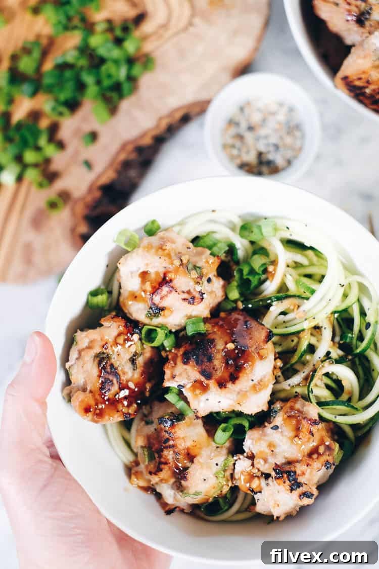 Close-up of succulent Paleo Asian Meatballs, perfectly baked and ready to be added to your noodle bowl.