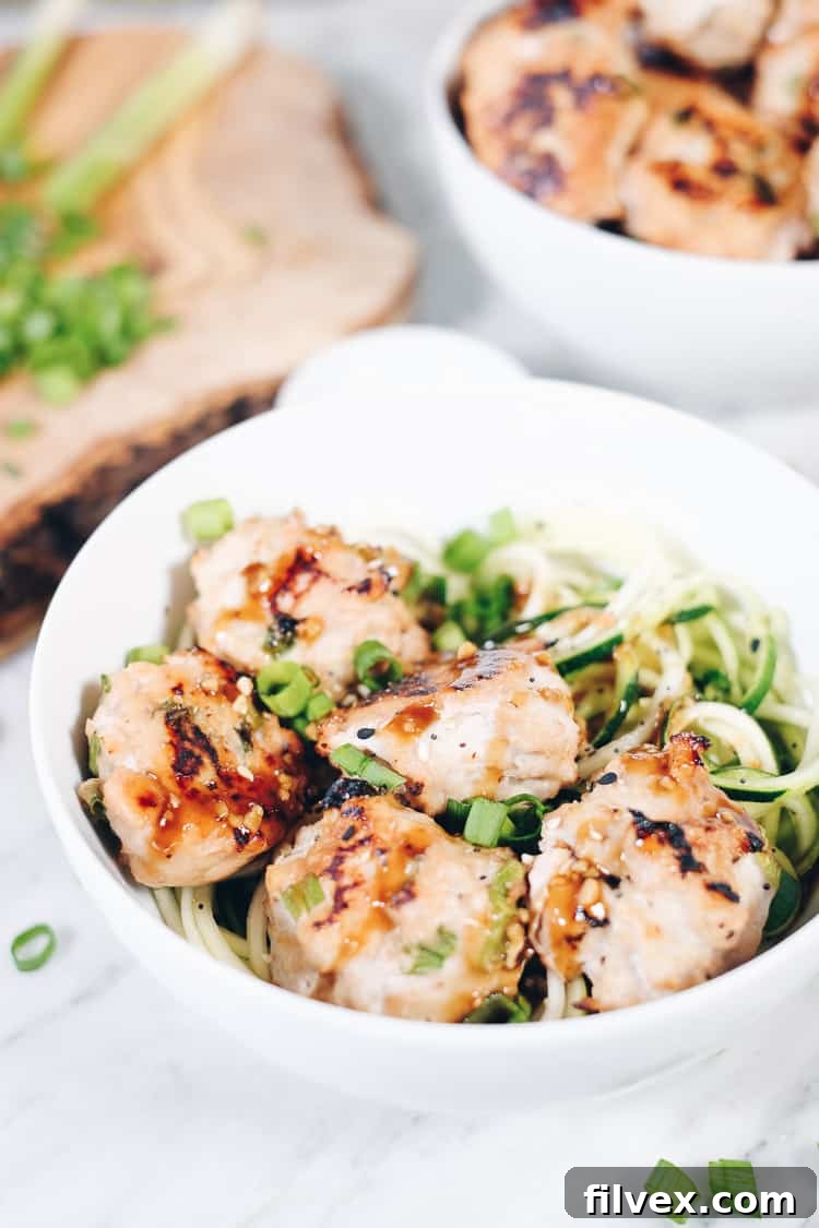Freshly spiralized zucchini noodles (zoodles) ready to be sautéed for a healthy and light noodle bowl base.