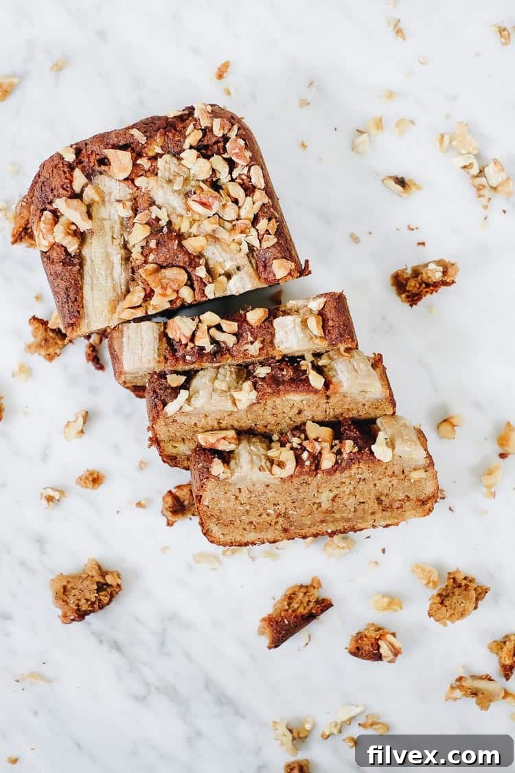 A close-up of a sliced Paleo Vegan Banana Bread revealing its moist, dense texture.