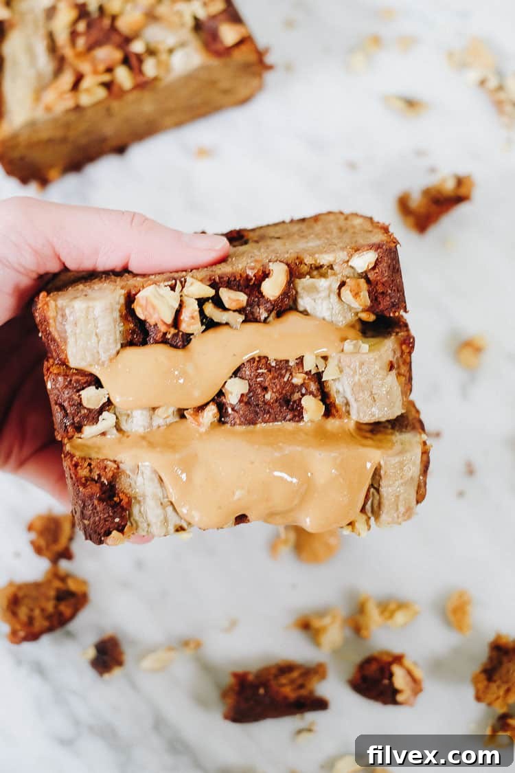 A delicious slice of Paleo Vegan Banana Bread topped with chocolate chips and nuts.