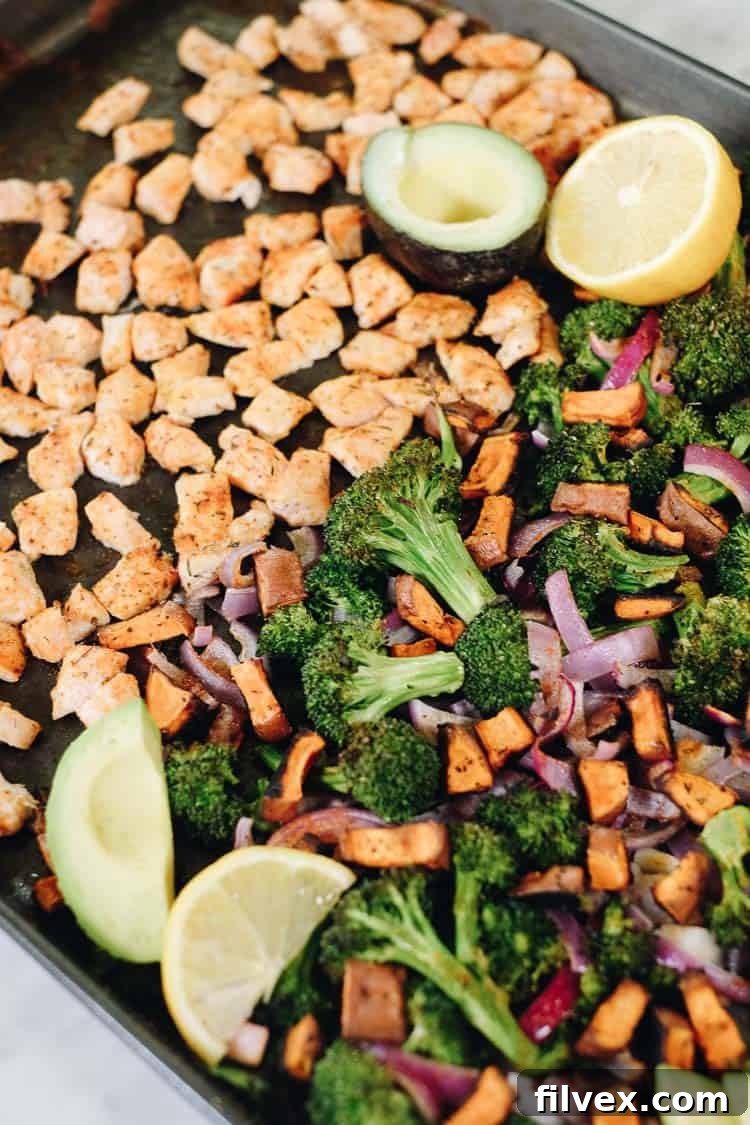 Close-up of a serving of Paleo and Whole30 chicken sweet potato bake, highlighting the roasted ingredients and fresh avocado. #paleo #whole30 #sheetpan #onepan | realsimplegood.com