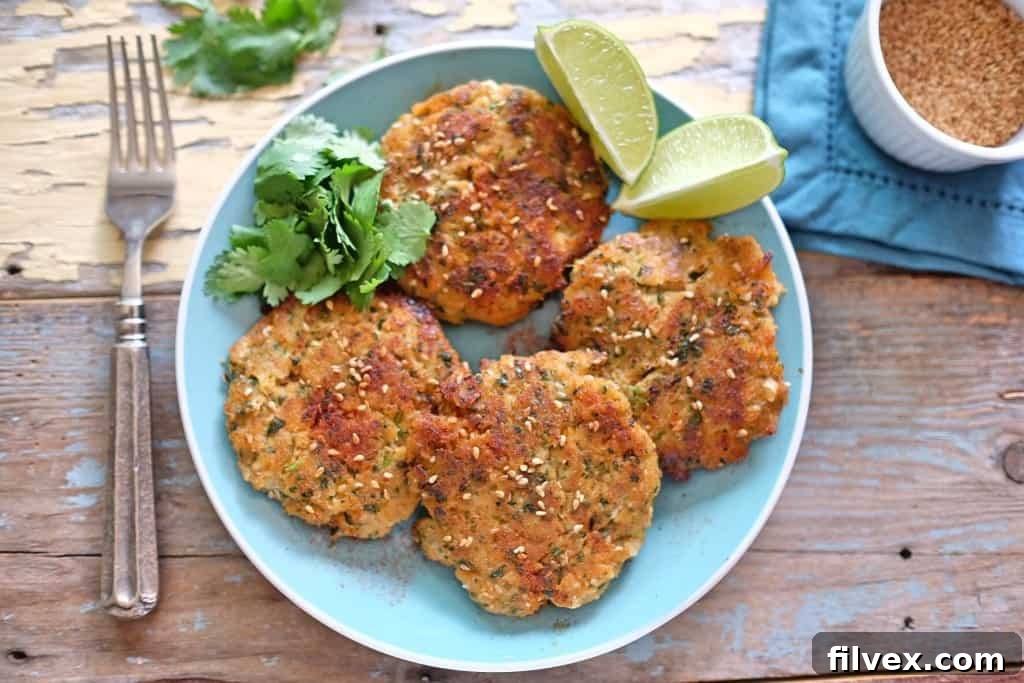 Sesame Ginger Fish Cakes - Crispy, golden-brown patties infused with ginger, cilantro, garlic, sesame, and lime.