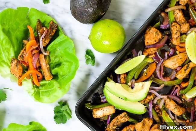 Sheet pan chicken fajita bake with avocado, lime and cilantro. Butter lettuce fajita shells.