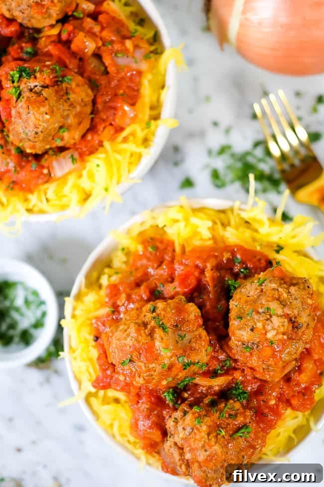 Instant Pot spaghetti and meatballs with parsley, fork and onion.