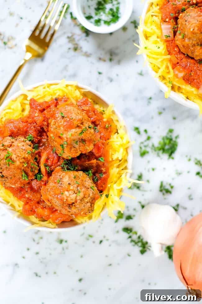 Instant Pot spaghetti and meatballs with parsley, fork, garlic and onion. 
