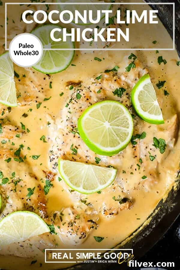 Close up of chicken in a skillet with sauce. Sliced limes on top.