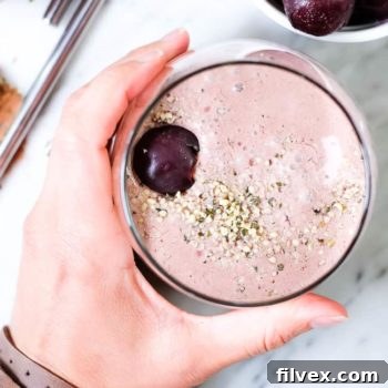 Close-up of a glass of the chocolate cherry smoothie, vibrant and appealing.