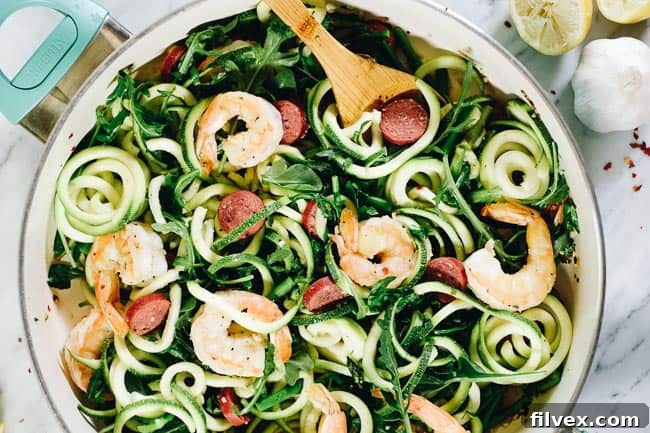 Lemon Garlic Shrimp Pasta in a skillet with wooden spoon. 